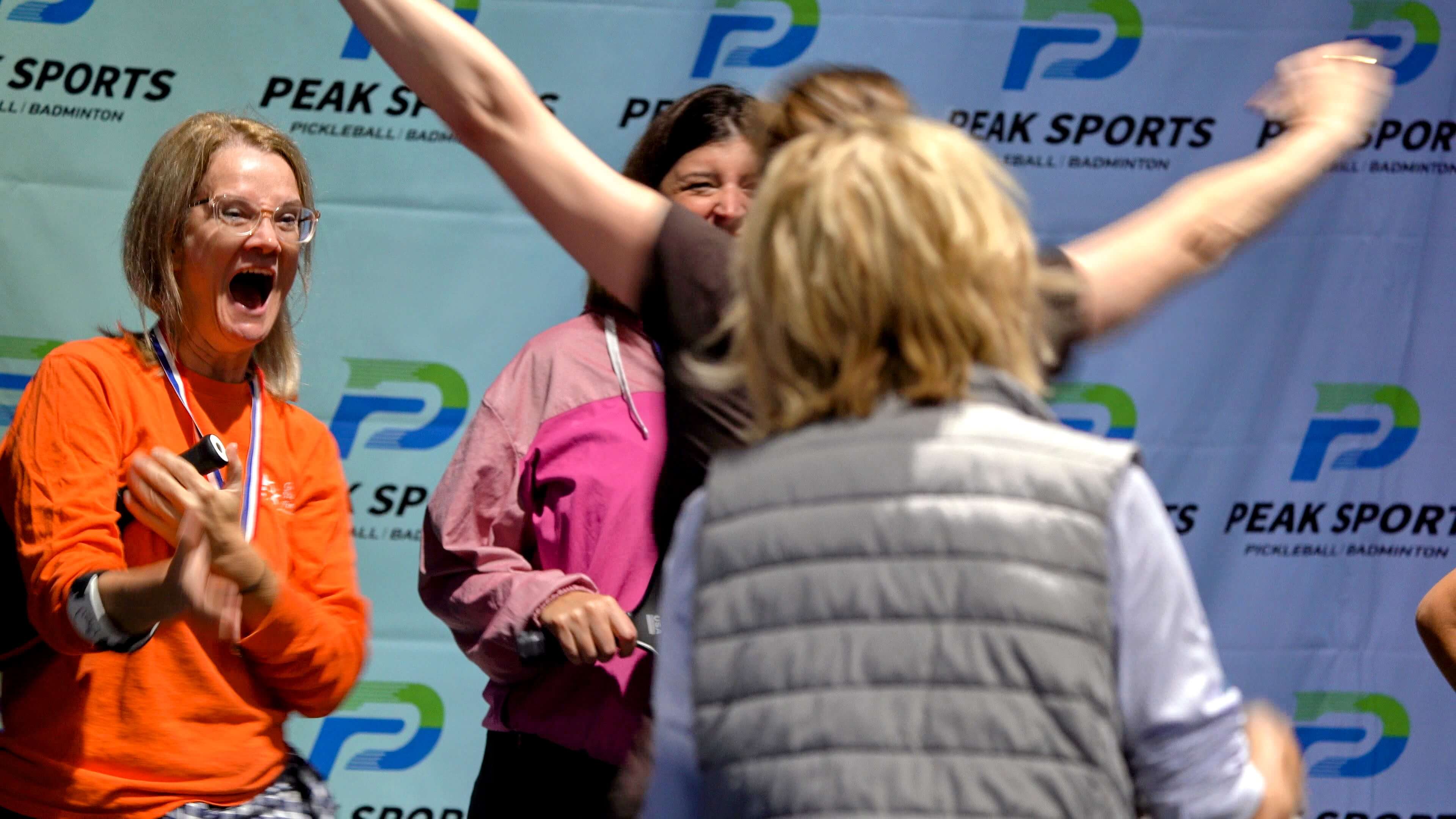 Tournament Victory Celebration - Women celebrating championship at Peak Sports event
